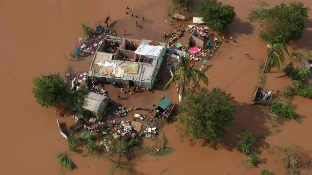 Aerial footage over poor African people with damaged houses and trees in the flood in Mozambique