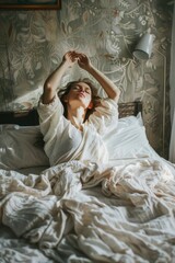 A woman laying in bed with her arms raised. Suitable for lifestyle or relaxation concepts