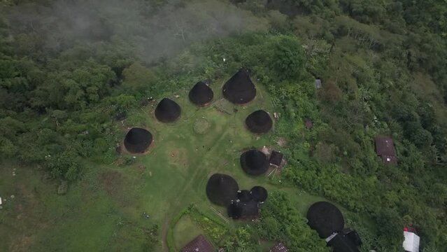 Aerial view of lush greenery and traditional houses in remote village, Wae Rebo, Flores, Indonesia.