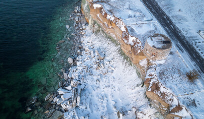 Limestone coastal cliff with an eroded and collapsed section near the historic lighthouse in Estonia
