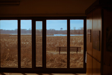 a bench in the middle of an empty hallway next to two glass doors