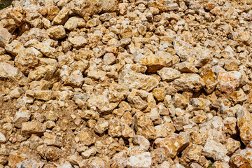 Blocks of limestone piled up in a crushed stone quarry