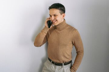 Handsome young man talking by phone 
