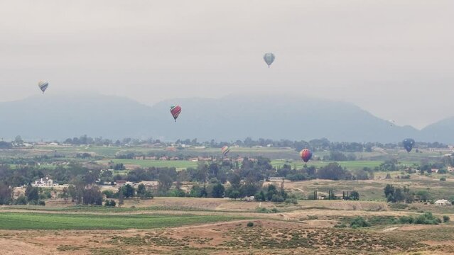 Temecula Balloon and Wine Festival Six Hot Air Balloons Drone Forward Motion Paraglider Flys Full Frame Left To Right