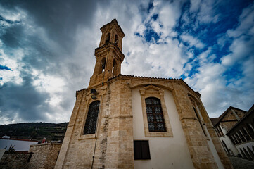 a clock tower sitting on the side of a building next to a street