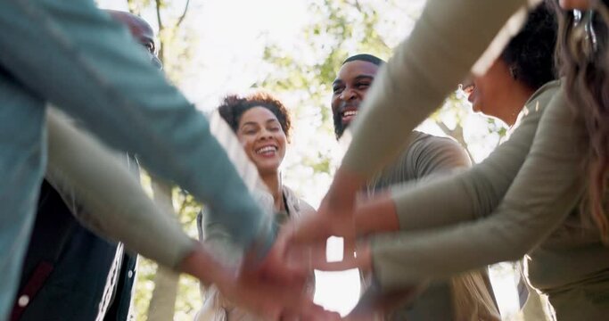 Outdoor, people or hands of volunteers in stack for support, community project or teamwork in nature sustainability. Low angle, recycling group or friends hug in charity service or NGO for pollution