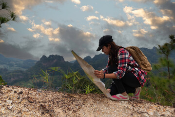 Hikers backpacks standing on top of a mountain and enjoying nature view