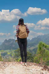 Hikers backpacks standing on top of a mountain and enjoying nature view