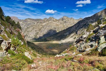 a river is next to a large mountain in the middle of it: Andorra, Pyrenees valley