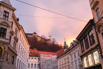 Vibrant cityscape with multiple illuminated buildings boasting red roofs in Ljubljana, Slovenia
