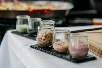 Set of assorted desserts presented in glass jars on a table