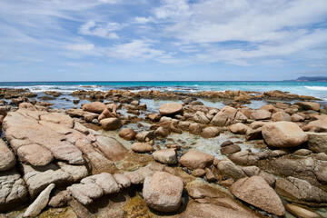Beautiful beach with rocks on it with the sea in the background in Bay of Fire, Tasmania, Australia