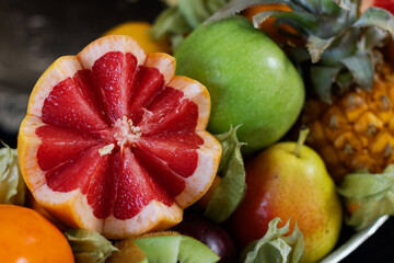 Silver bowl filled with assorted fruits and vegetables