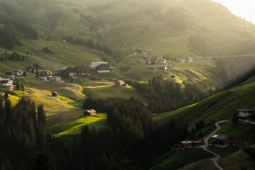 Scenic view of idyllic village nestled amidst green mountains in Warth, Austria.