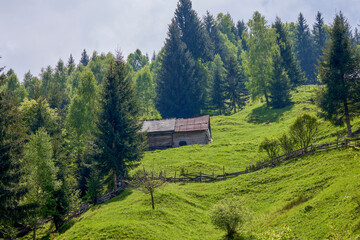 mountain landscape with old wooden houses in Bucegi mountains Romania.