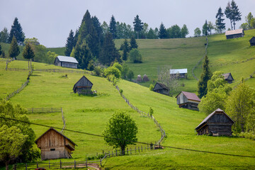 mountain landscape with old wooden houses in Bucegi mountains Romania.