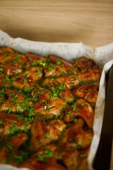 baked chicken wings with a golden crust lie on a tray