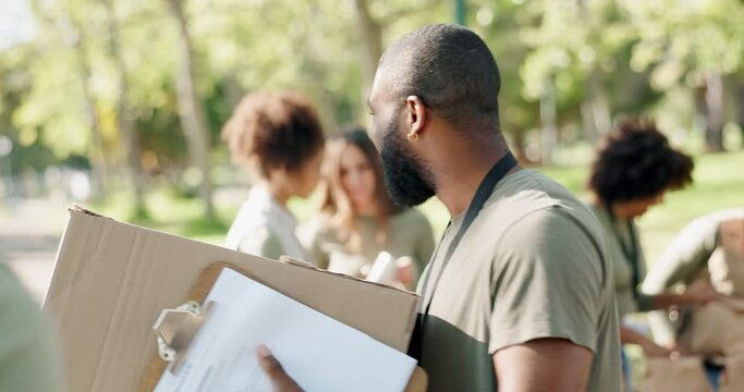 Park, volunteers and happy people with boxes in charity event for care, kindness or helping in nature. Community donation, carry and volunteering at ngo for food package distribution in group project