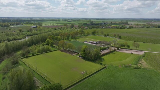 Aerial view of soccer field and football field surrounded by trees and fields, Beesd, Netherlands.