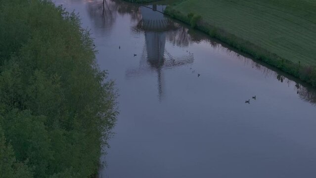 Aerial view of De Vlinder windmill, river Linge, and sunrise, Deil, Netherlands.