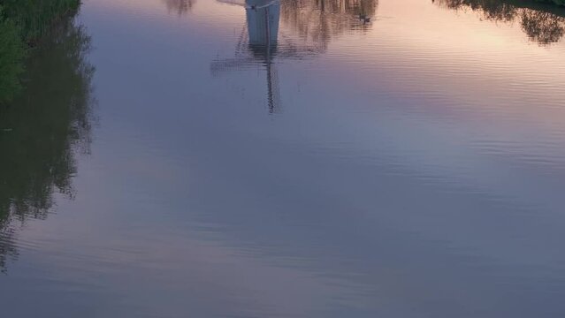 Aerial view of windmill, river, and De Vlinder at sunrise along River Linge, Deil, Gelderland, Netherlands.