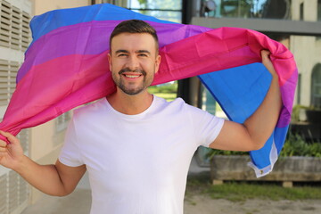 Proud man waving the bisexual flag 