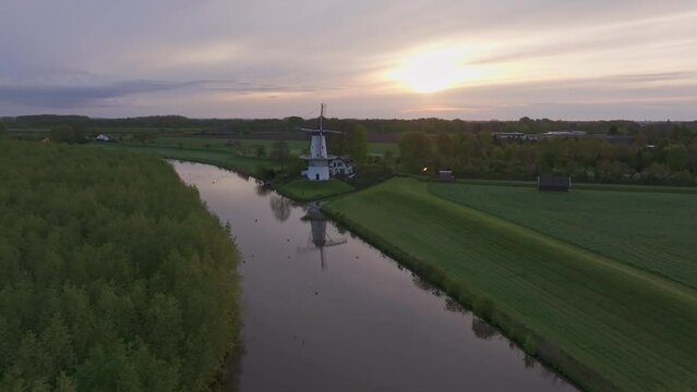 Aerial view of De Vlinder windmill, river Linge, and sunrise, Deil, Netherlands.