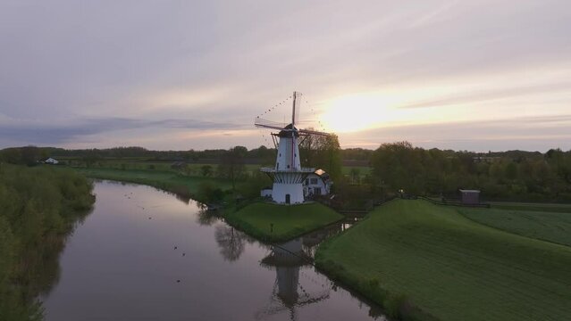 Aerial view of De Vlinder windmill, river Linge, at sunrise, Deil, Gelderland, Netherlands.