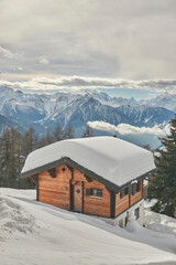 Snow-covered cabin nestled in the mountains. Bettmeralp, Switzerland