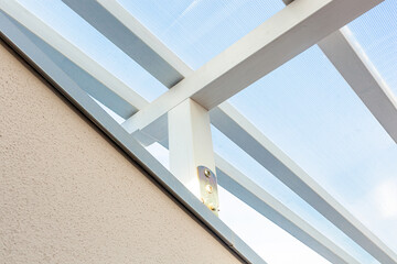 Wooden shed maintenance with wave. Cracks in the wood and rust in the iron struts.