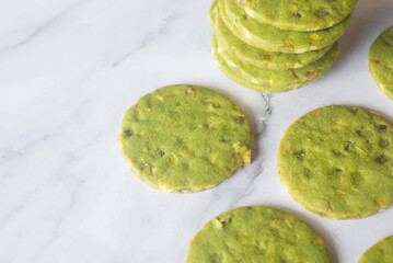 matcha green tea shortbread cookies with orange candy and macadamia nut.