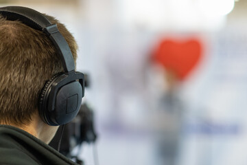 Cameraman recording insightful moments at a media conference, capturing the essence of discussions...