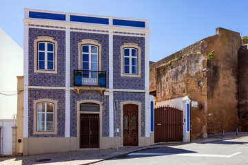 Blue and yellow tile facade refurbished neoclassical house on Rua da Atalaia street in the old...