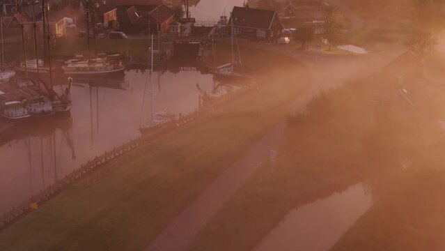 Aerial view of picturesque Workum with canal, boats, and foggy morning, Friesland, Netherlands.