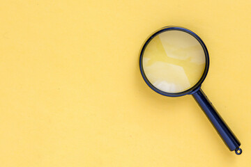 close up magnifier glass on yellow background