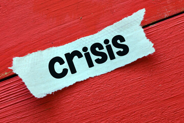 CRISIS. Word crisis written on a piece of paper. Economic crisis concept.