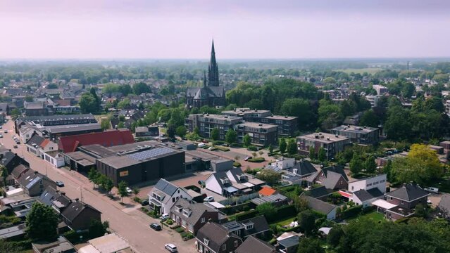 Dutch traditional centre of Brabant town Budel and catholic church drone zoom in
