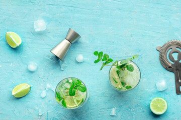 Mojito cocktail. Summer cold drink with lime, fresh mint, and ice. Cool beverage on a blue...