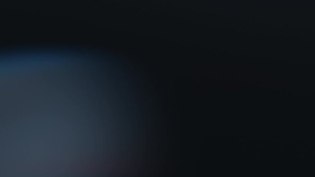 Abstract effect of the blurry bokeh lights moving on a black background