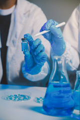 chemist,scientist hand dropping chemical liquid into test tube, science research and development...