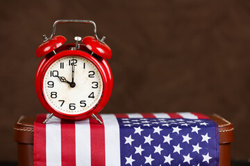 Alarm clock on a USA flag. Happy Independence Day, freedom background with copy space.