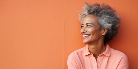 Coral Background Happy black american independant powerful Woman. Portrait of older mid aged person beautiful Smiling girl Isolated on Background ethnic 