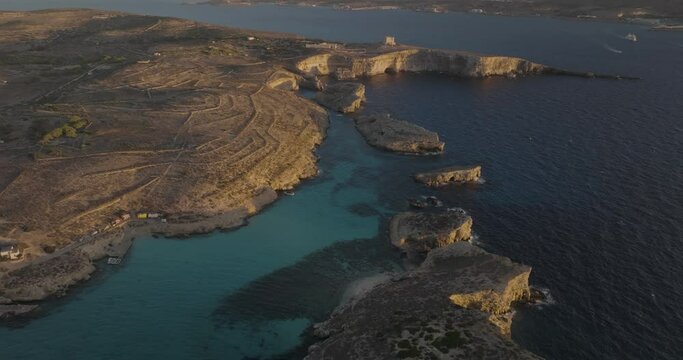 Aerial view of rugged cliffs and serene coastline at Gozo cliffs, Comino island, Malta.