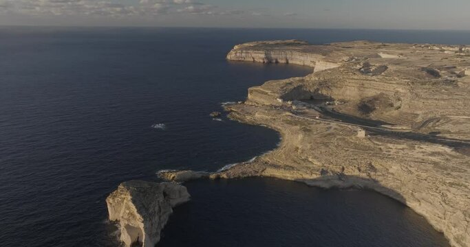 Aerial view of rugged Gozo cliffs and Dwejra Bay, Munxar, Malta.