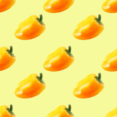 Pattern of ripe yellow bell peppers on a yellow background