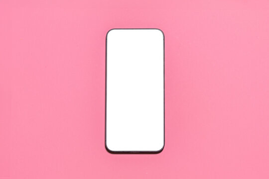 Smartphone with blank screen isolated on a pink background.