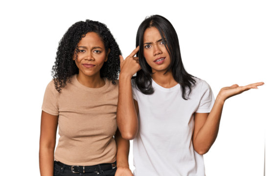 Young Latin friends in studio holding and showing a product on hand.