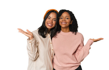 Young Latin friends together in studio makes scale with arms, feels happy and confident.