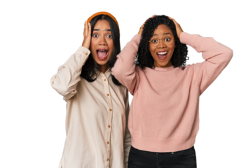 Young Latin friends together in studio screaming, very excited, passionate, satisfied with something.