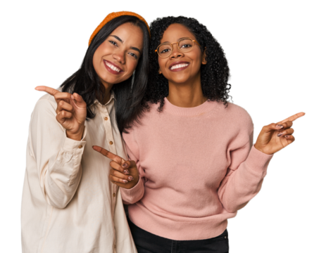 Young Latin friends together in studio pointing to different copy spaces, choosing one of them, showing with finger.